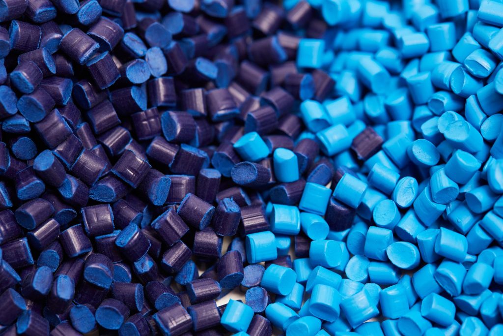 two stacks of blue plastic polypropylene granules